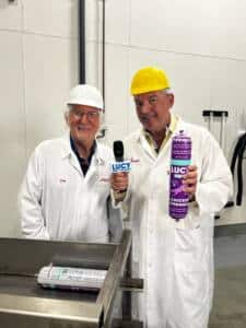 Joey at factory showing Lucy Pet Food Rolls